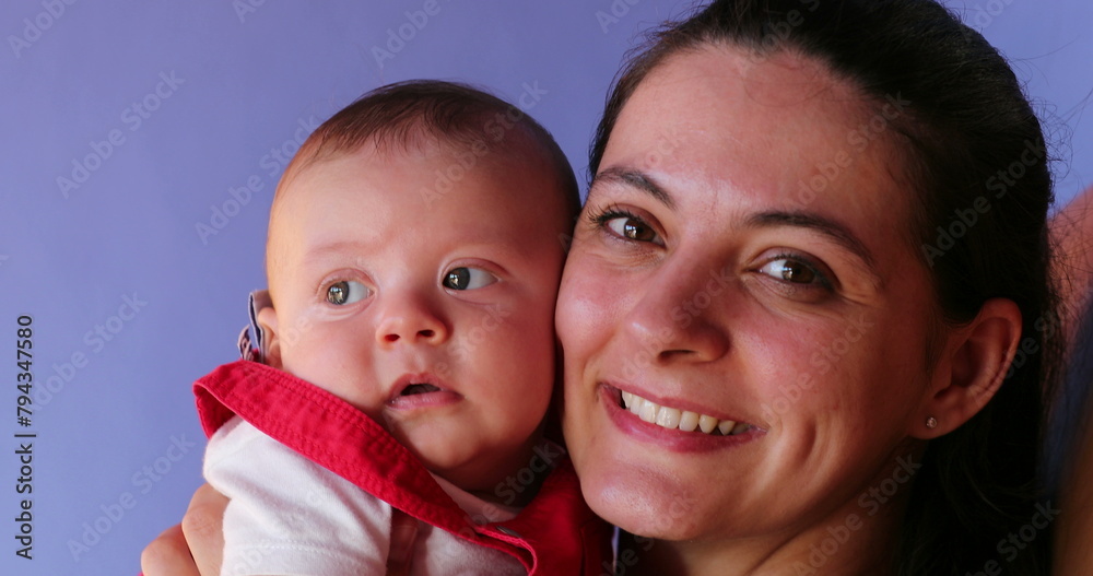 Mother posing with baby boy for photo looking to camera Mother posing with baby boy for photo looking to camera