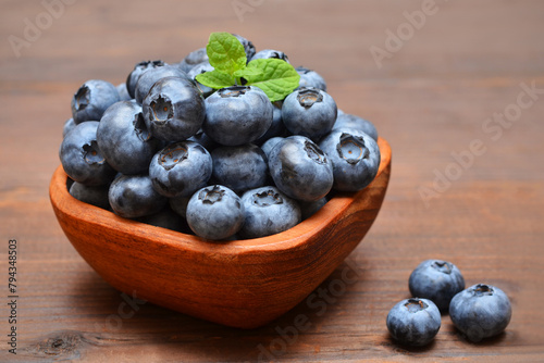 garden blueberries in a wooden bowl close-up