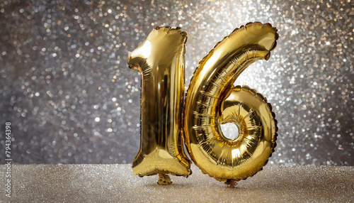 Banner with number 16 golden balloon. 16 years anniversary celebration. Silver glitter background. photo