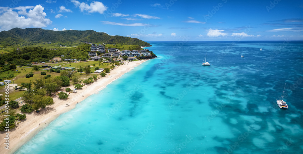 Aerial view of the beautiful Ffryes Beach at the Caribbean island of Antigua with turquoise sea and fine sand Aerial view of the beautiful Ffryes Beach at the Caribbean island of Antigua with turquoise sea and fine sand