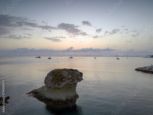 Vista aerea dell'alba del porto di Lacco Ameno ad Ischia. Roccia, mare, sole e mille colori photo