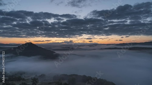 Full Sunrise aerial view Timelapse vidéo over Auvergne mountains from Correze, with sunlight, sunrays, and orange fog