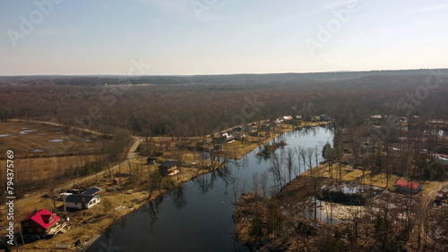 Am aerial view of a lake and cottages.  © davorbozo