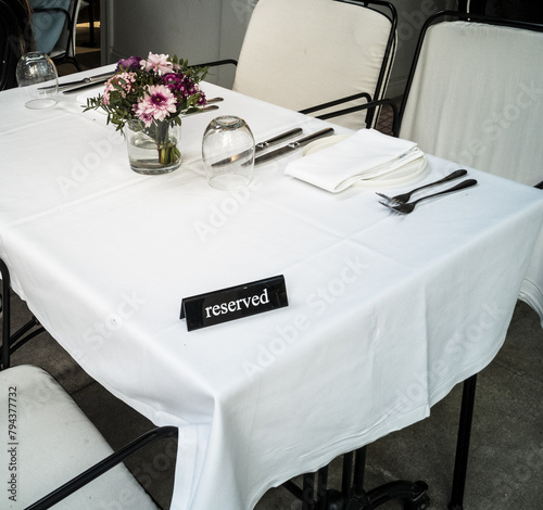 reserved white table with flowers photo