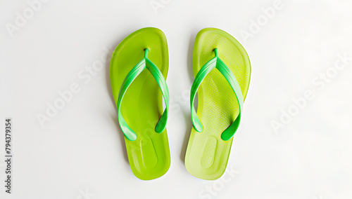 Pair of Green flip-flops on white background.