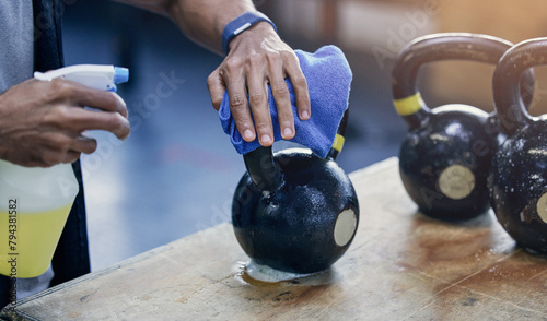 People, cleaning and gym or kettlebell with detergent for hygiene, health and wellness from bacteria. Cleaner, man and hand to disinfect or sanitise with product for protection or safety from virus photo