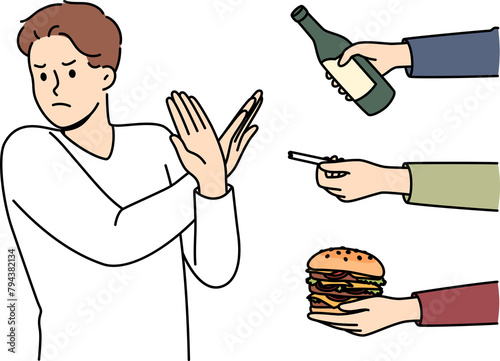 Man gives up bad habits, making forbidden gesture near hands with alcohol and cigarettes or fast food. Guy says stop bad habits to start healthy lifestyle and avoid loss of immunity