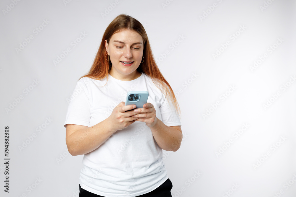 Smiling young brunette woman with smart phone posing isolated on white background, studio portrait. Cute beautiful 30s woman chatting by mobile phone Smiling young brunette woman with smart phone posing isolated on white background, studio portrait. Cute beautiful 30s woman chatting by mobile phone