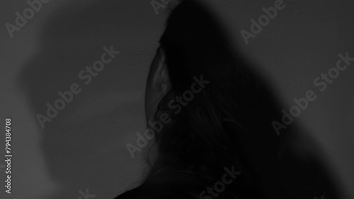 Overlay of two videos a girl waves her head and raises her head, black and white video, stress and emotions photo