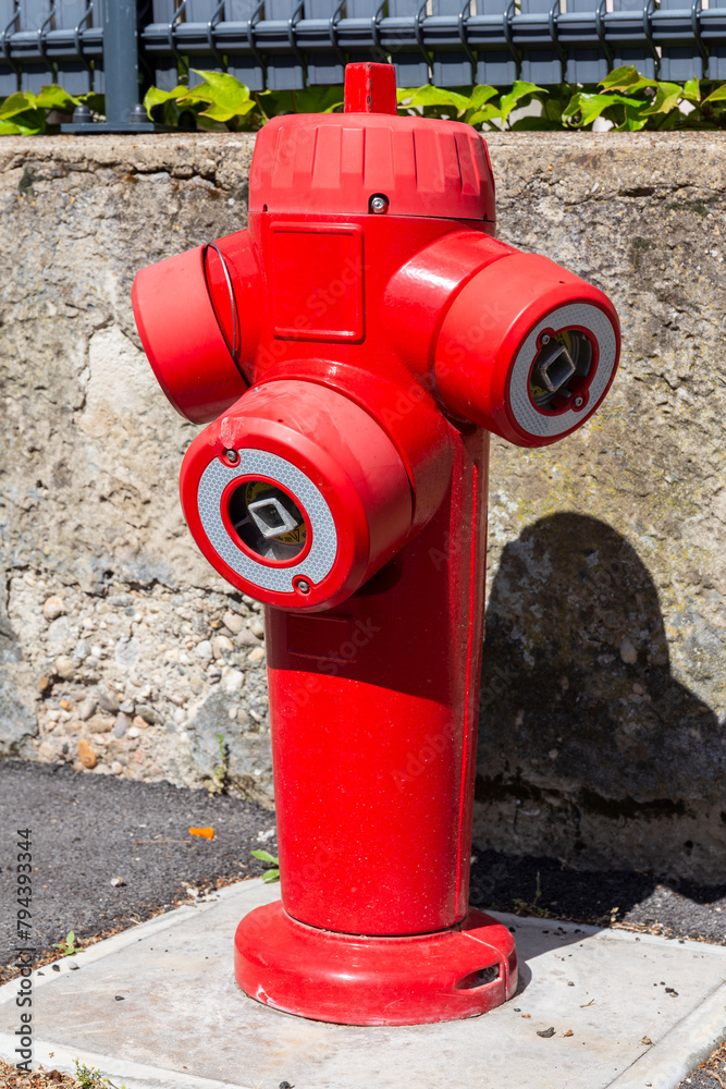 Fire hydrant in french street. Red triple fire hydrant on the street, close up profil. Fire hydrant in french street. Red triple fire hydrant on the street, close up profil.