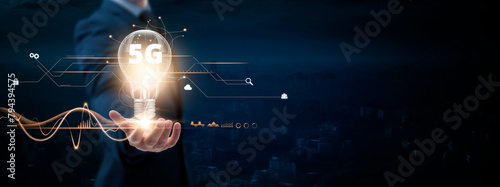 5G: Businessman holding creative light bulb with Digital networking and 5G icons. Innovation, Connectivity, Advancement, on blue city background.