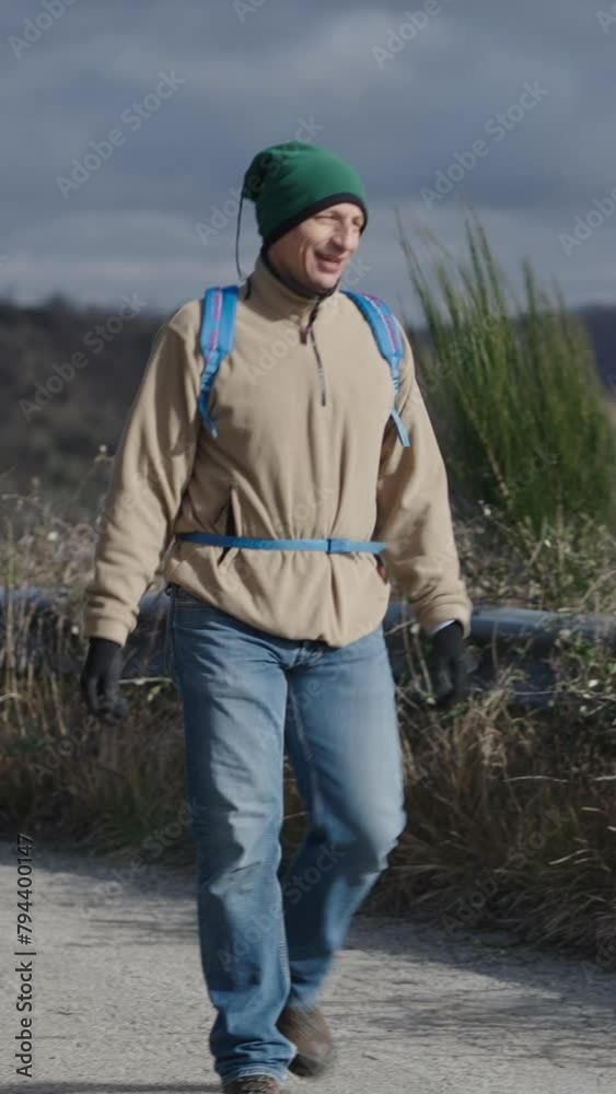 A man walks along a mountain road