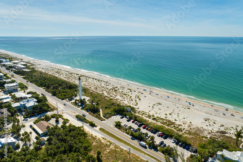 Famous lighthouse on ocean shore and expensive residential houses in island small town Boca Grande on Gasparilla Island in southwest Florida