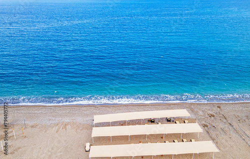 Aerial  view of the beach with sunbeds and umbrella at Kemer, Antalya by drone