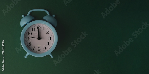 alarm clock on a green background