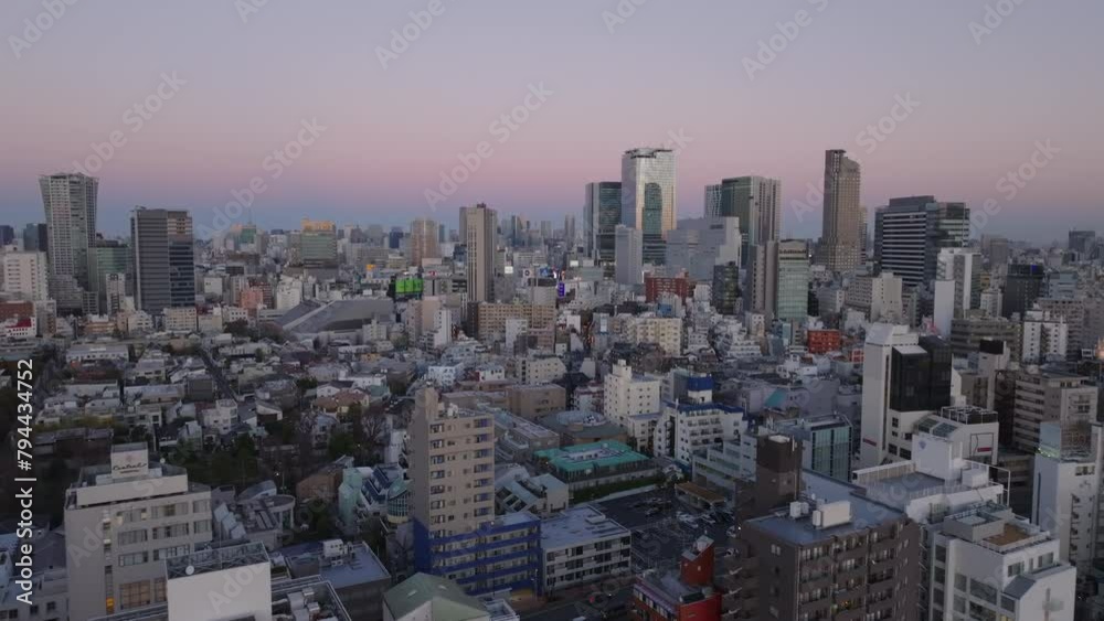 Aerial panoramic view of urban borough with modern high rise buildings against sky at dusk. Tokyo, Japan Aerial panoramic view of urban borough with modern high rise buildings against sky at dusk. Tokyo, Japan