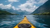 A yellow kayak on the water with mountains in the background