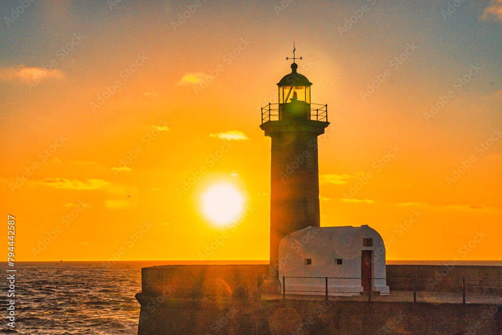 Felgueiras Lighthouse in silhouette with beautiful colorful sunset sky. Porto, Portugal. 