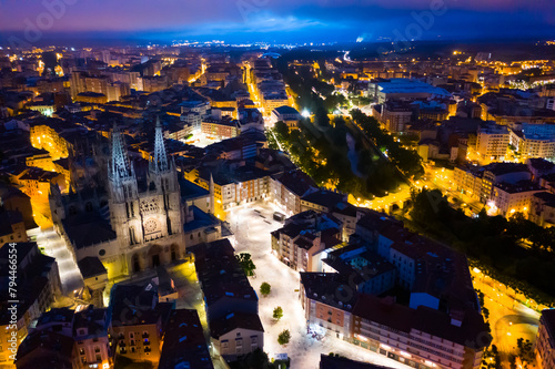 View from drone of impressive Burgos Gothic Cathedral on background of illuminated cityscape at night, Spain.. photo