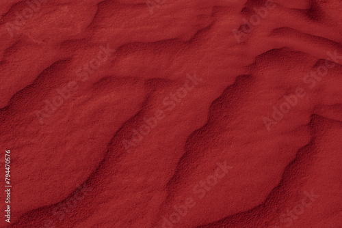 red desert sand shaped into waves by the wind