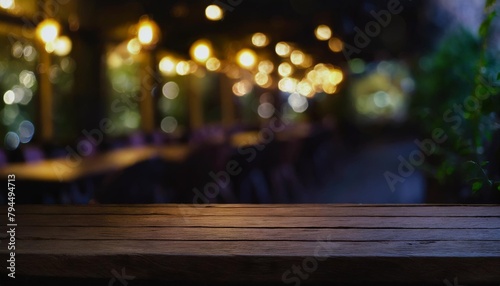 dark wooden table with no one at it in front of restaurant background with an abstract bokeh effect might be employed to montage or display your merchandise