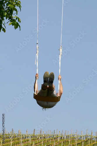 person on a swing on a hot summer day #794514541