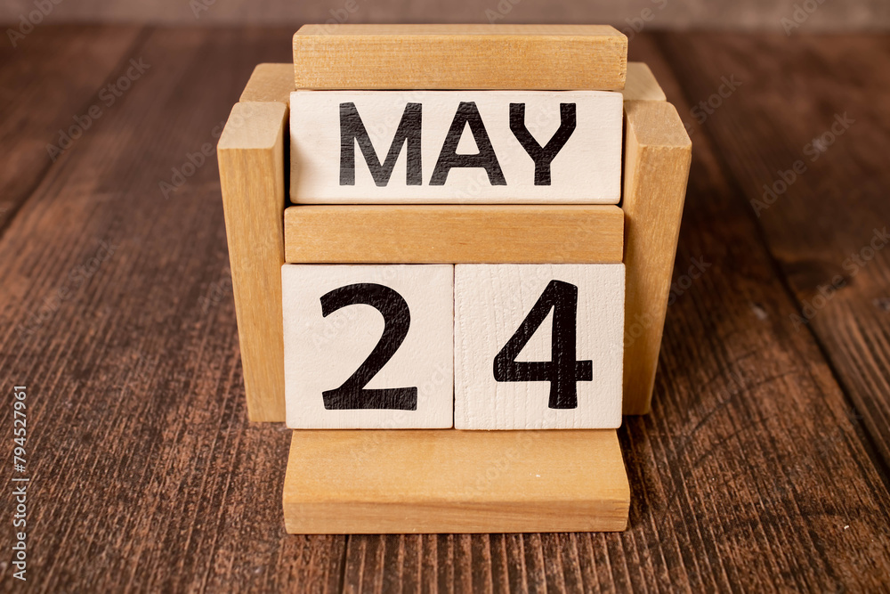 May 24th calendar date text on white wooden block on wooden desk