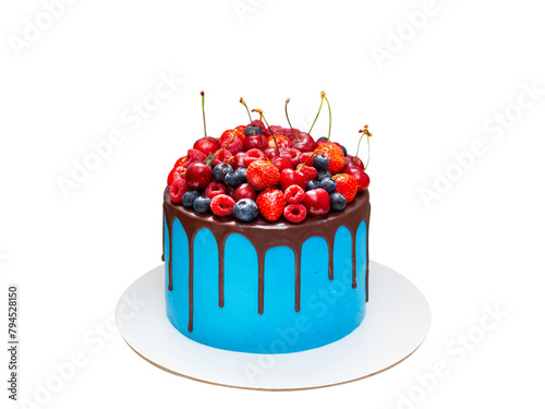 Beautiful blue birthday cake decorated with fresh berries with a place for a label. The concept of summer desserts for a birthday