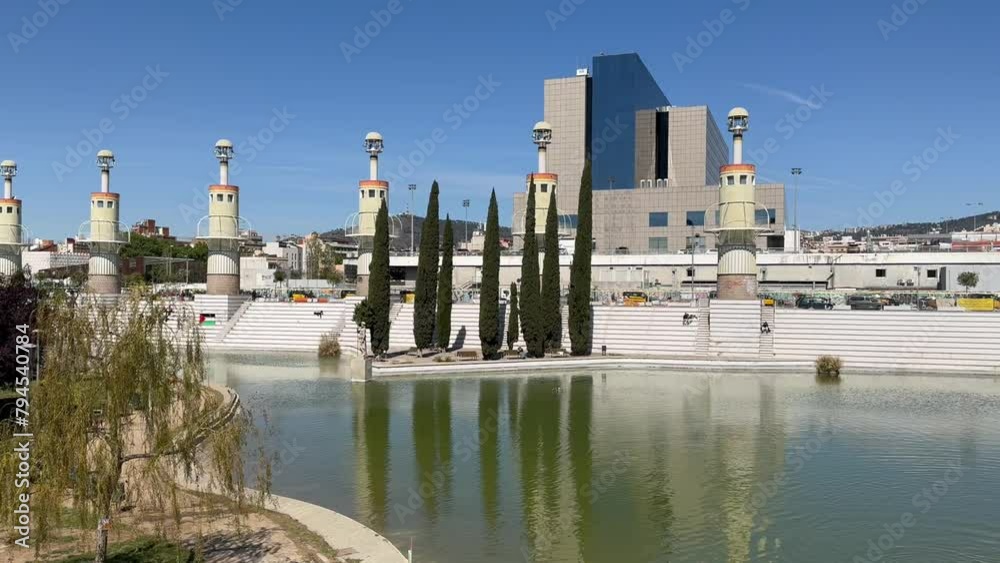 BARCELONA, SPAIN - April 14, 2024: This is a modern Industrial Spain Park, created on the site of the former industrial zone of the city. Ponds, weeping willows and lighthouses. A place to relax.