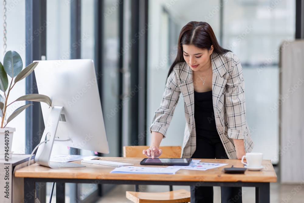Portrait of an Asian businesswoman smiling while sitting at her desk.doing planning analyzing the financial report, business plan investment, finance analysis concept.
Portrait of an Asian businesswoman smiling while sitting at her desk.doing planning analyzing the financial report, business plan investment, finance analysis concept.