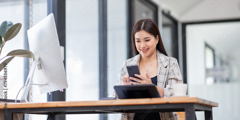 Portrait of young Asian businesswoman in suit, woman smiling and work at workplace inside office, accountant with calculator behind paper phone signing contracts and financial reports Portrait of young Asian businesswoman in suit, woman smiling and work at workplace inside office, accountant with calculator behind paper phone signing contracts and financial reports