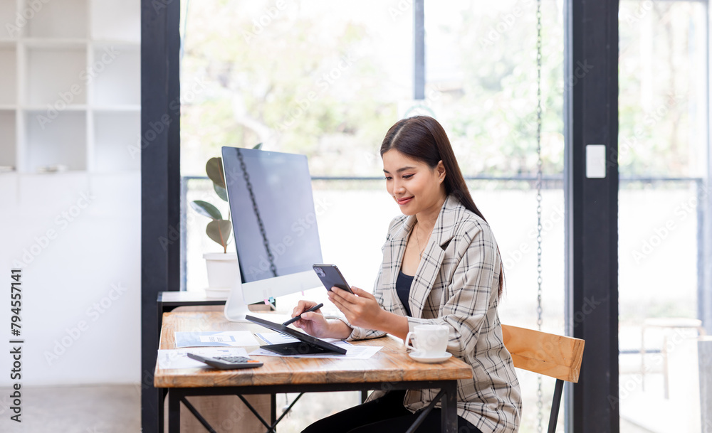 Portrait of young Asian businesswoman in suit, woman smiling and work at workplace inside office, accountant with calculator behind paper phone signing contracts and financial reports Portrait of young Asian businesswoman in suit, woman smiling and work at workplace inside office, accountant with calculator behind paper phone signing contracts and financial reports