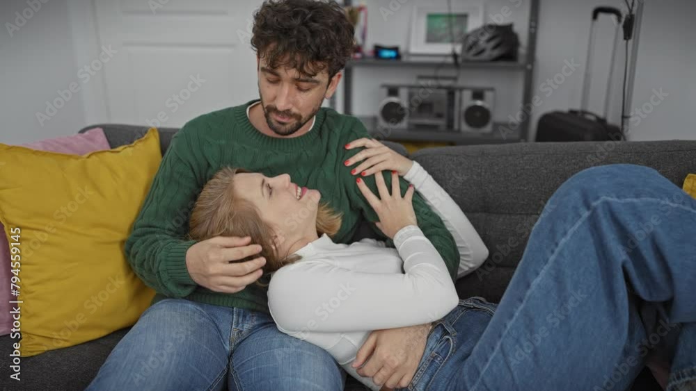 A loving couple embraces affectionately on a couch in a cozy living room, sharing a moment of tenderness. A loving couple embraces affectionately on a couch in a cozy living room, sharing a moment of tenderness.