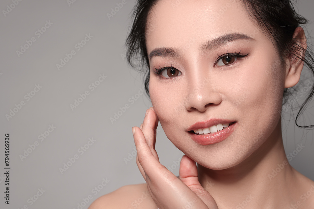 Portrait of beautiful woman on grey background Portrait of beautiful woman on grey background