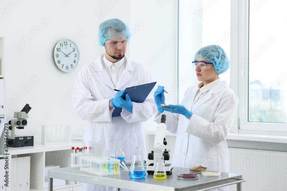 Quality control. Food inspectors checking safety of products in laboratory