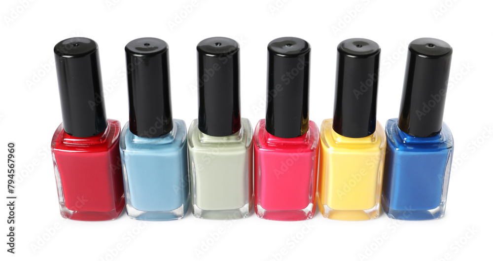 Bright nail polishes in bottles isolated on white Bright nail polishes in bottles isolated on white