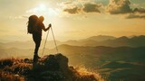 A silhouette of a hiker backpack and walking stick in hand stands atop a hill taking in the breathtaking view of the rugged terrain . .