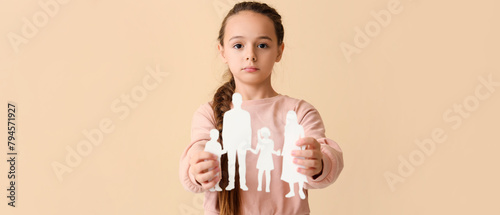 Little girl with family figure on beige background. Divorce concept