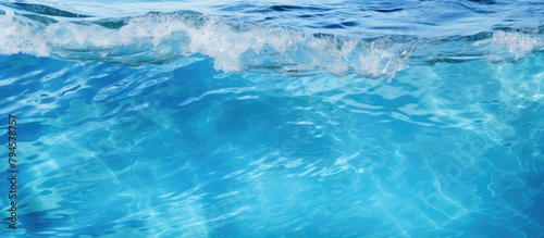 Close up of a wind wave in the electric blue ocean water