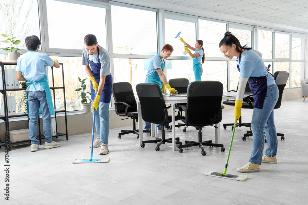 © Pixel-Shot - Team of young janitors cleaning in office