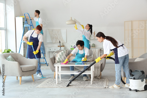 Group of young janitors cle...