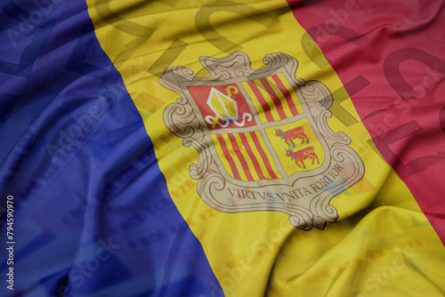 waving colorful national flag of andorra on a euro money banknotes background. finance concept.
