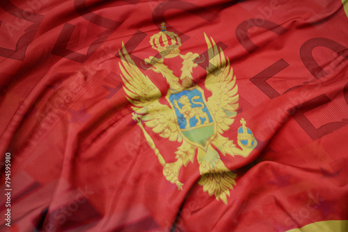 waving colorful national flag of montenegro on a euro money banknotes background. finance concept.