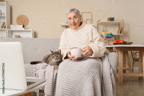 Senior woman with cup of te...
