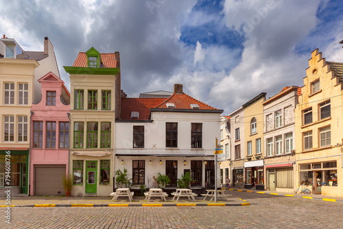 Charming row of colorful traditional houses on a cobblestone street in Ghent, Belgium.