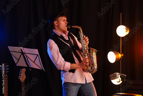 Handsome man playing saxoph...