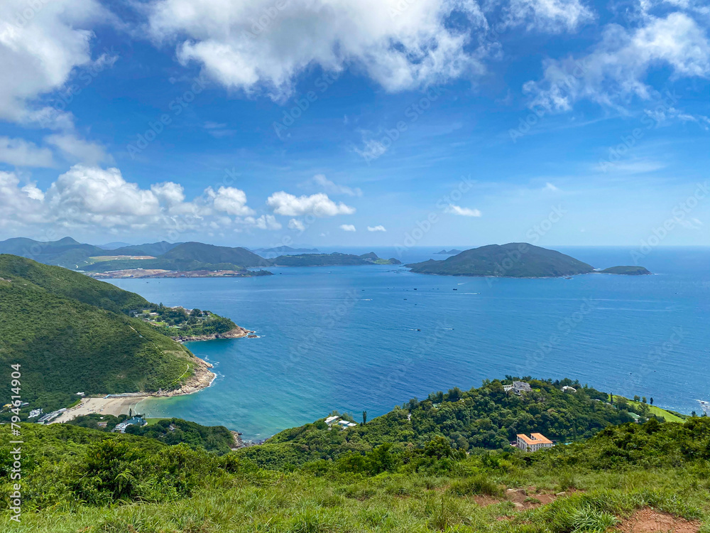 Fototapeta premium Panoramic View of Lush Greenery and Tranquil Ocean, Hong Kong Island