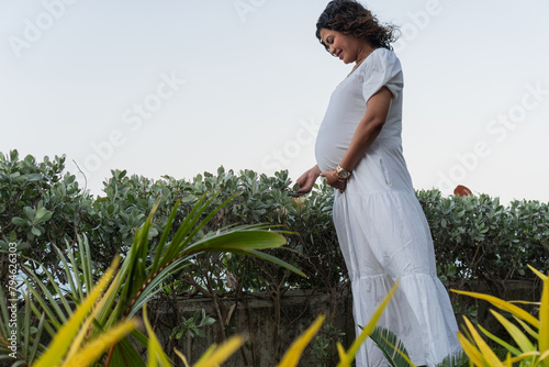 Expectant Mother Amongst Lakeside Foliage at Dusk