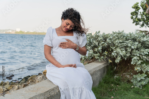 Expectant Mother's Blissful Moment by the Sea