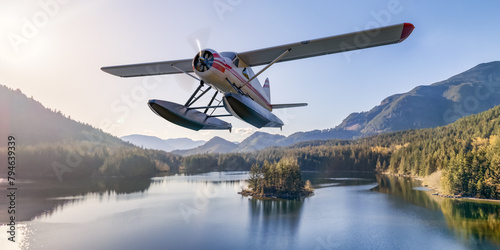 Floatplane flying over Canadian Lake and mountain landscape. Aerial BC, Canada